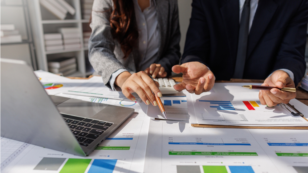 Business bookkeeping with calculator of bookkeeper and household calculating chart graph annual financial account.